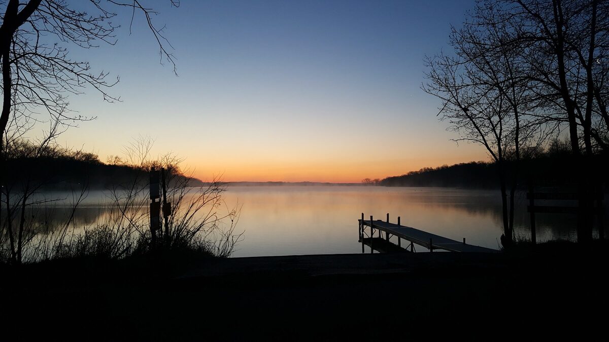 Sunrise over a Central Minnesota lake with dock